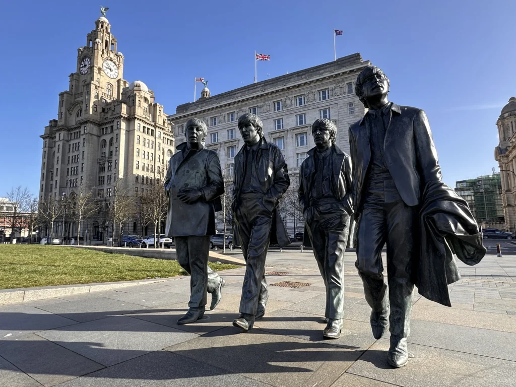 The Beatles Statue in front of the Liver Building with Blue Skies - Liverpool March 2024