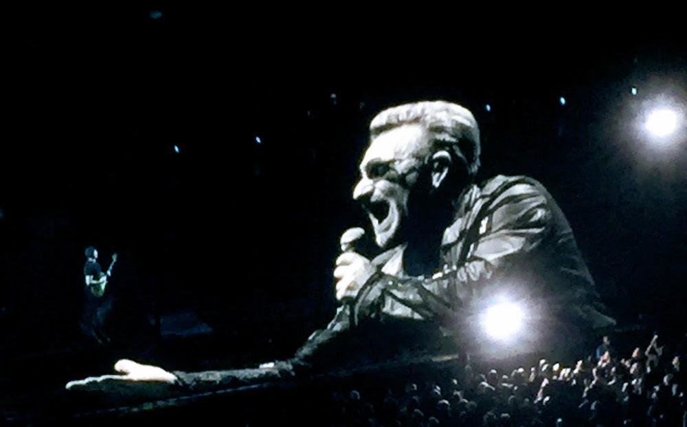U2's Bono and the Edge above a concert crowd