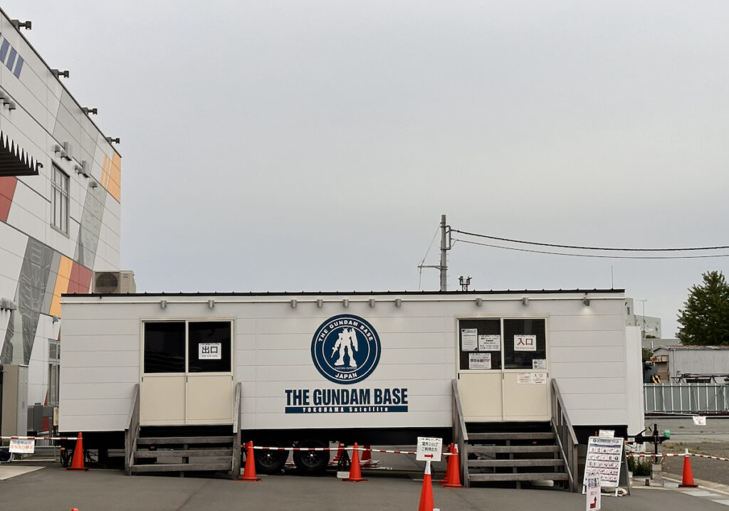 An operations trailer with Gundam Base writing and logo 