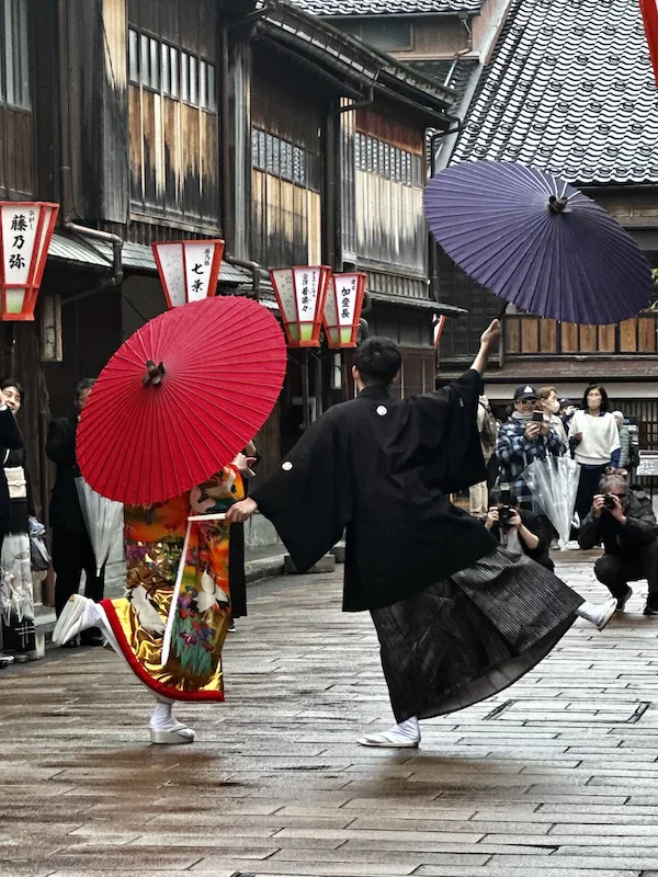 A recently married couple pose in traditional Japanese dress for photographers in the old Geisha district of Kanwazawa