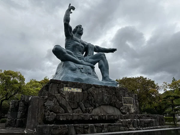 The imposing Peace statue points to the sky in Nagasaki