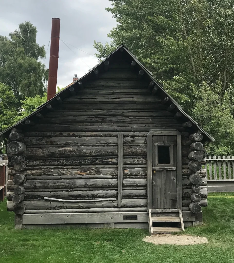A small wooden building with no decoration and a small door - the oldest home in Skagway 