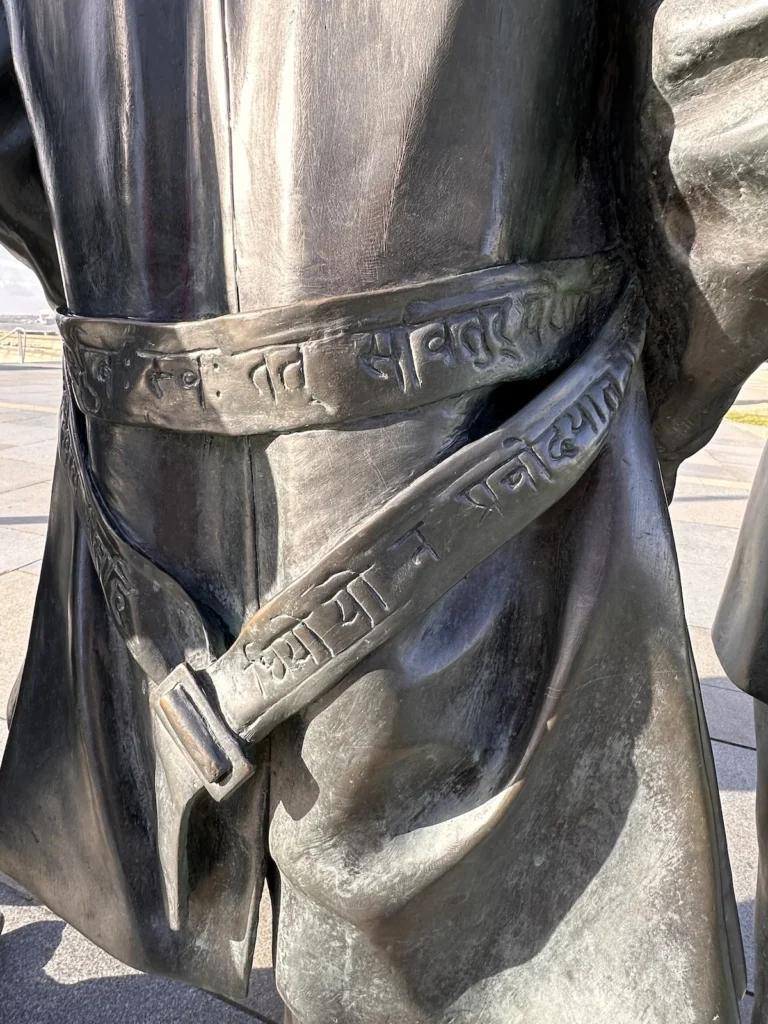 At the back of George Harrison's hangs his belt with the Sanskrit inscription