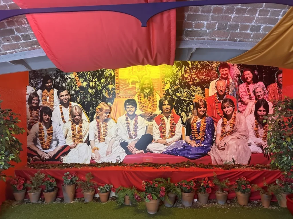A recreation of a photo showing the Beatles and friends including Pattie Boyd, in India