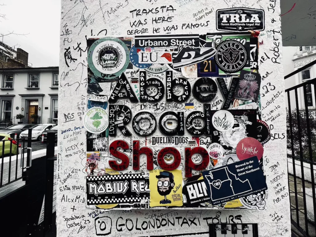 Graffiti on the white wall of London's Abbey road shop