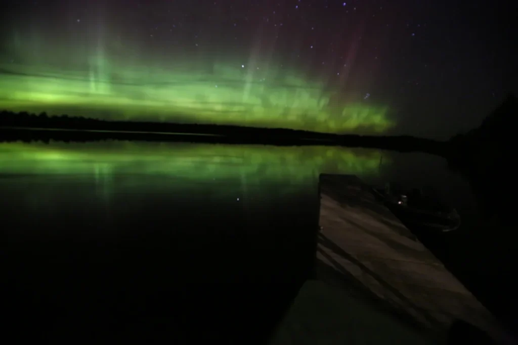 Green Aurora Borealis light up the night sky over Voyageurs National Park in Alaska