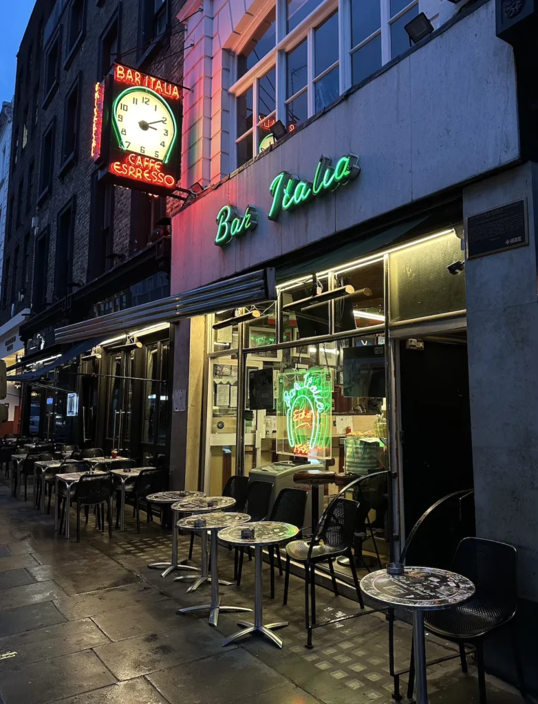 The Bar Italia sign lit up in Italian colours at night on Frith Street