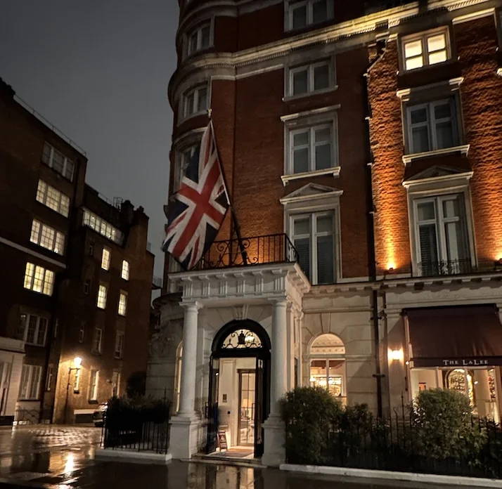 The front door of the Cadogan Hotel with Union Jack above the door, taken on a dark wet night in London