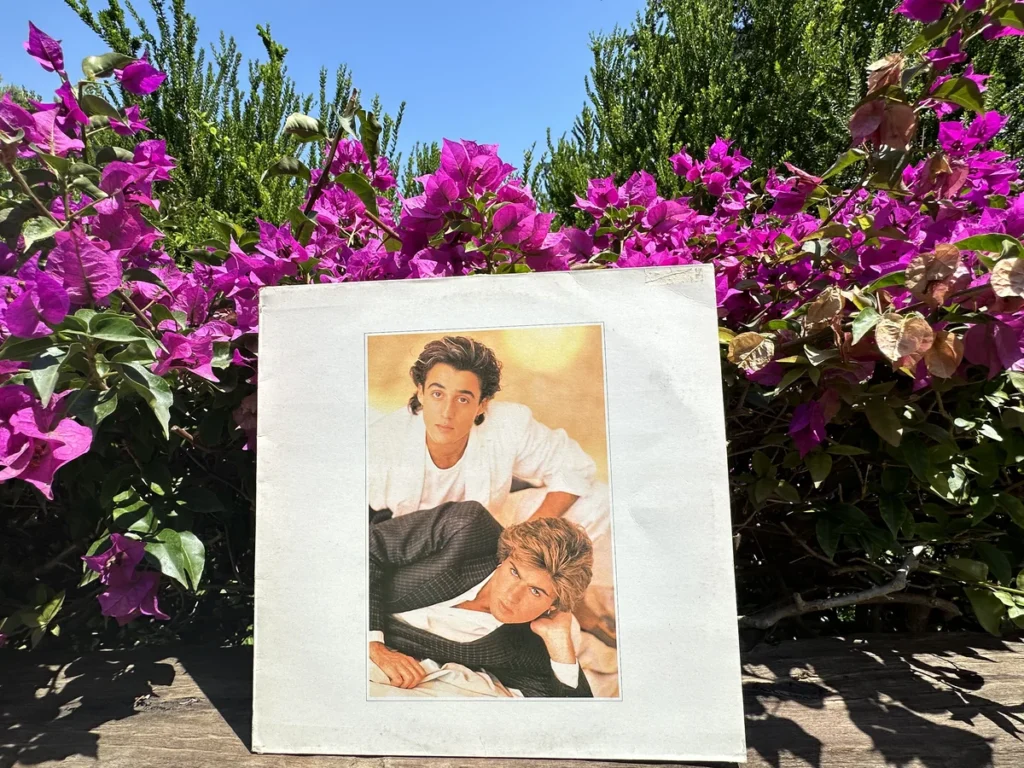 A copy of the Wham Album Make it Big against a bright blue background of the South of France