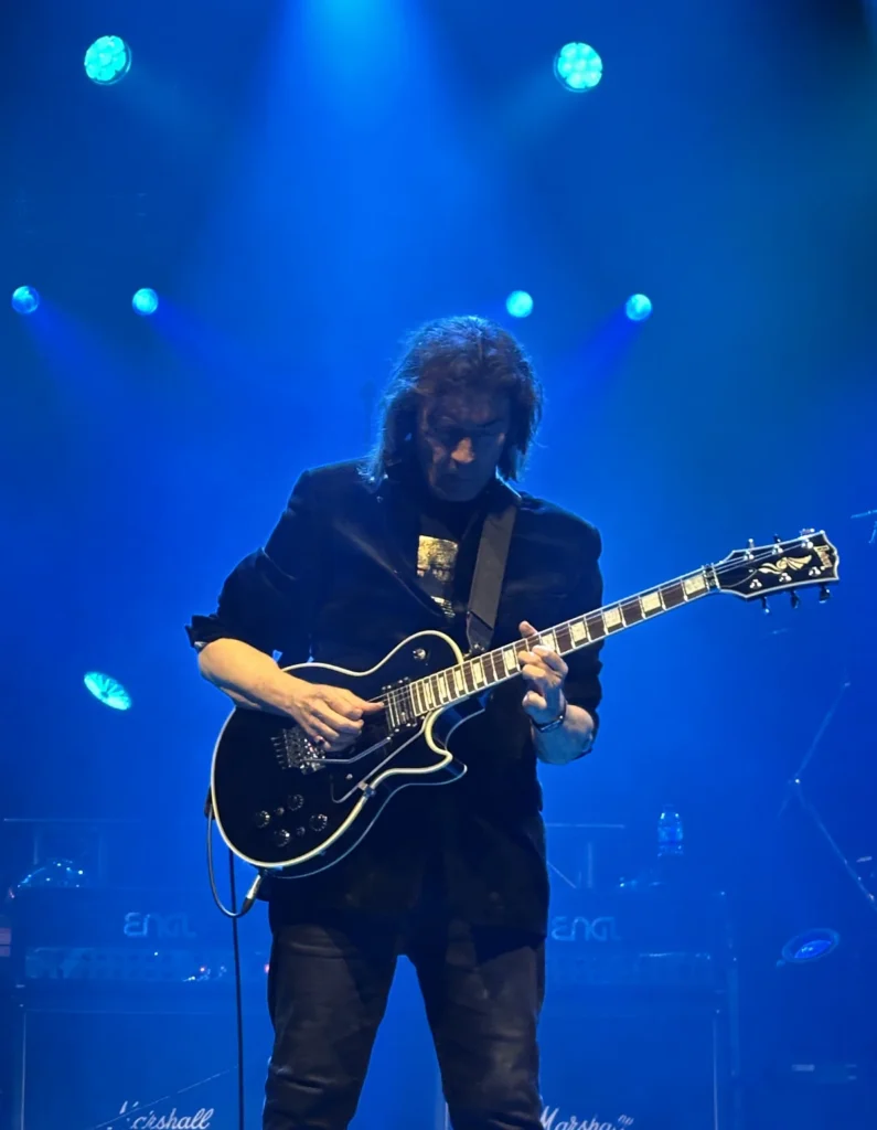 Steve Hackett in Blue Light playing a guitar solo at the Cambridge Corn Exchange 