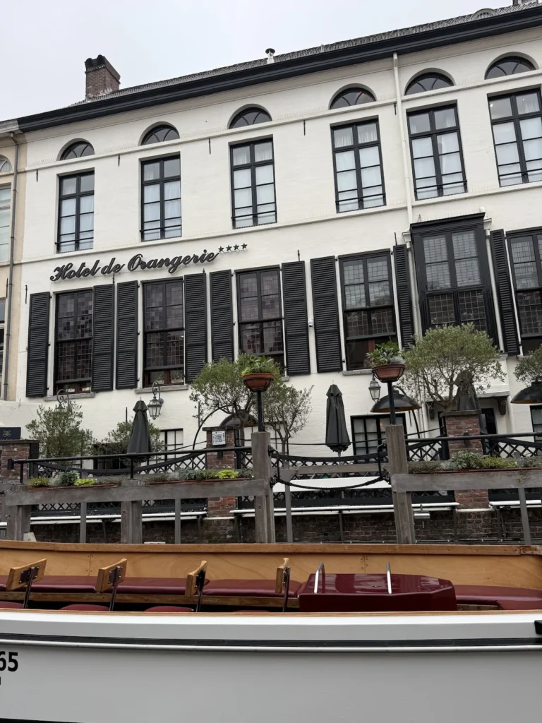 The white exterior of the Hotel D'Orangerie on a dull day in Bruges