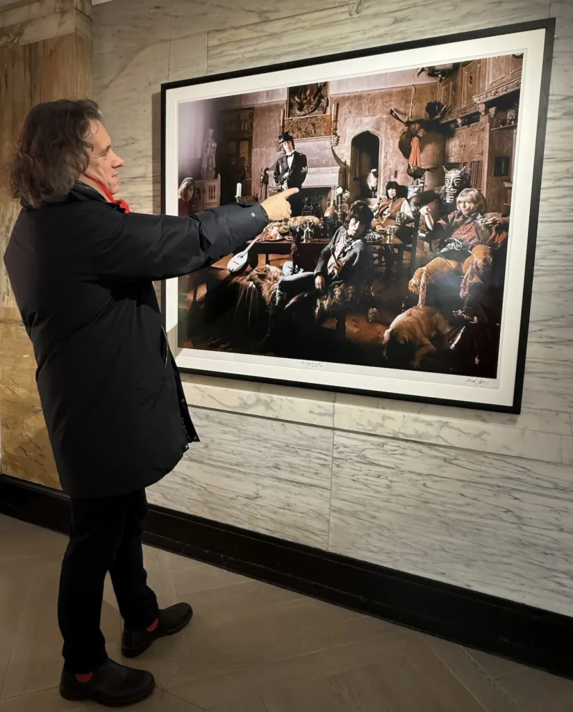 The author pointing at the Beggars Banquet Photo highlighting the presence of a sheep on the stairs