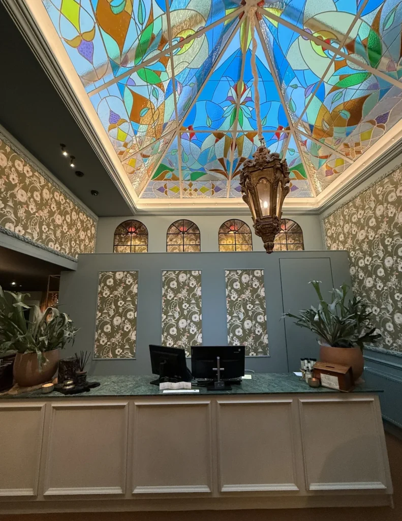 A glazed internal ceiling stands above the hotel reception