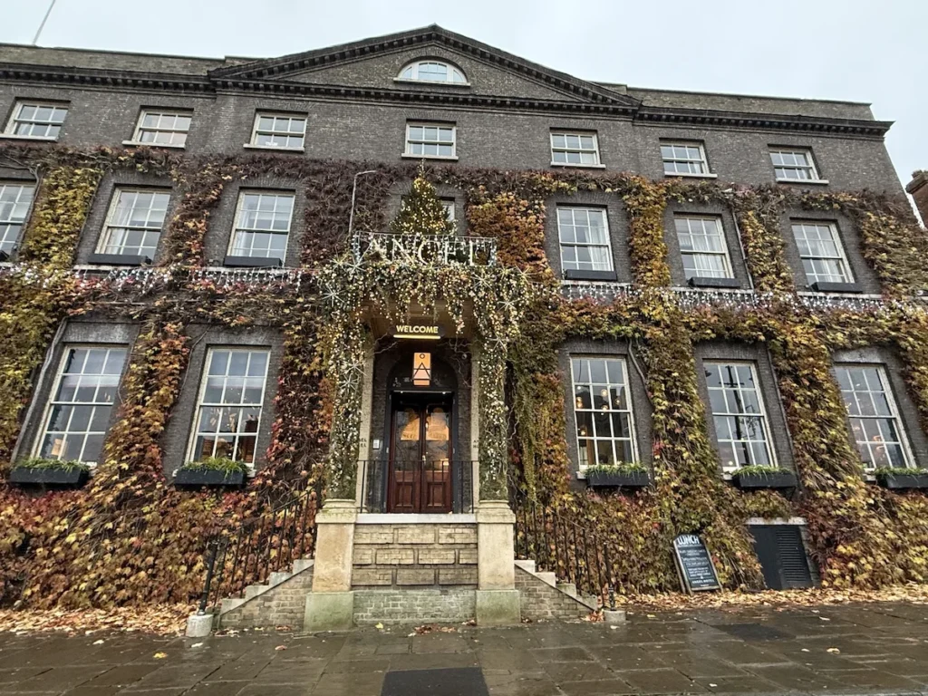 The ivy clad grey exterior of the Angle Hotel in Bury St Edmunds on a dull and damp November day 