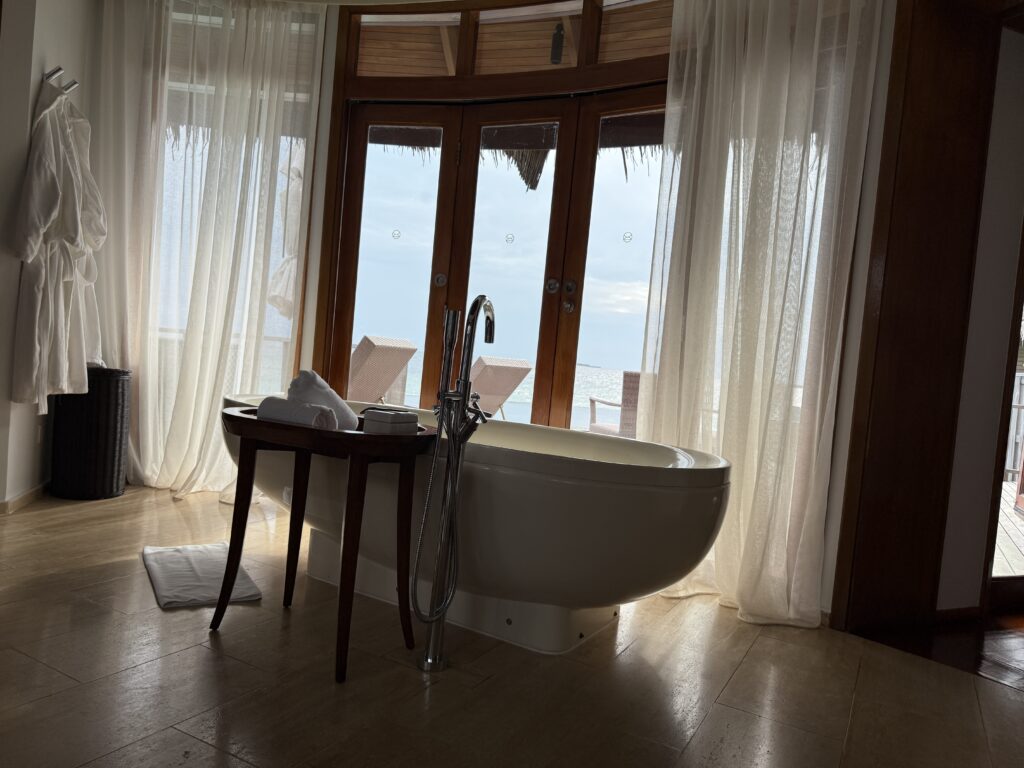 An almond shaped bath at Constance Halaveli Over Water Villa