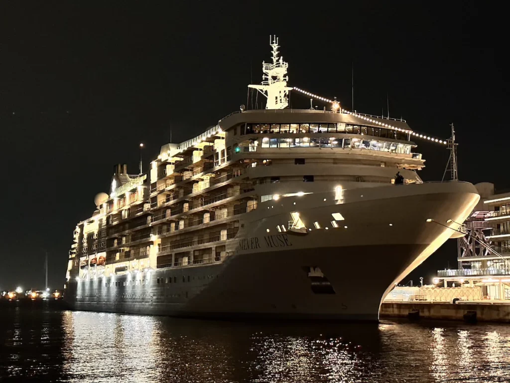 The Silver Muse cruise ship docked in Yokohama, with the city skyline in the background